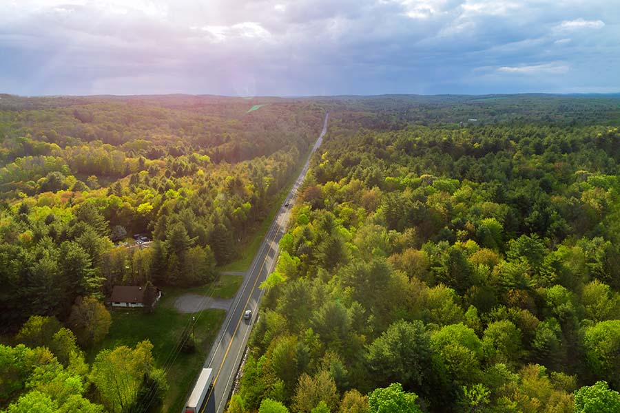Contact - Aerial View of Small Rural Road Surrounded By Forests in Pennsylvania